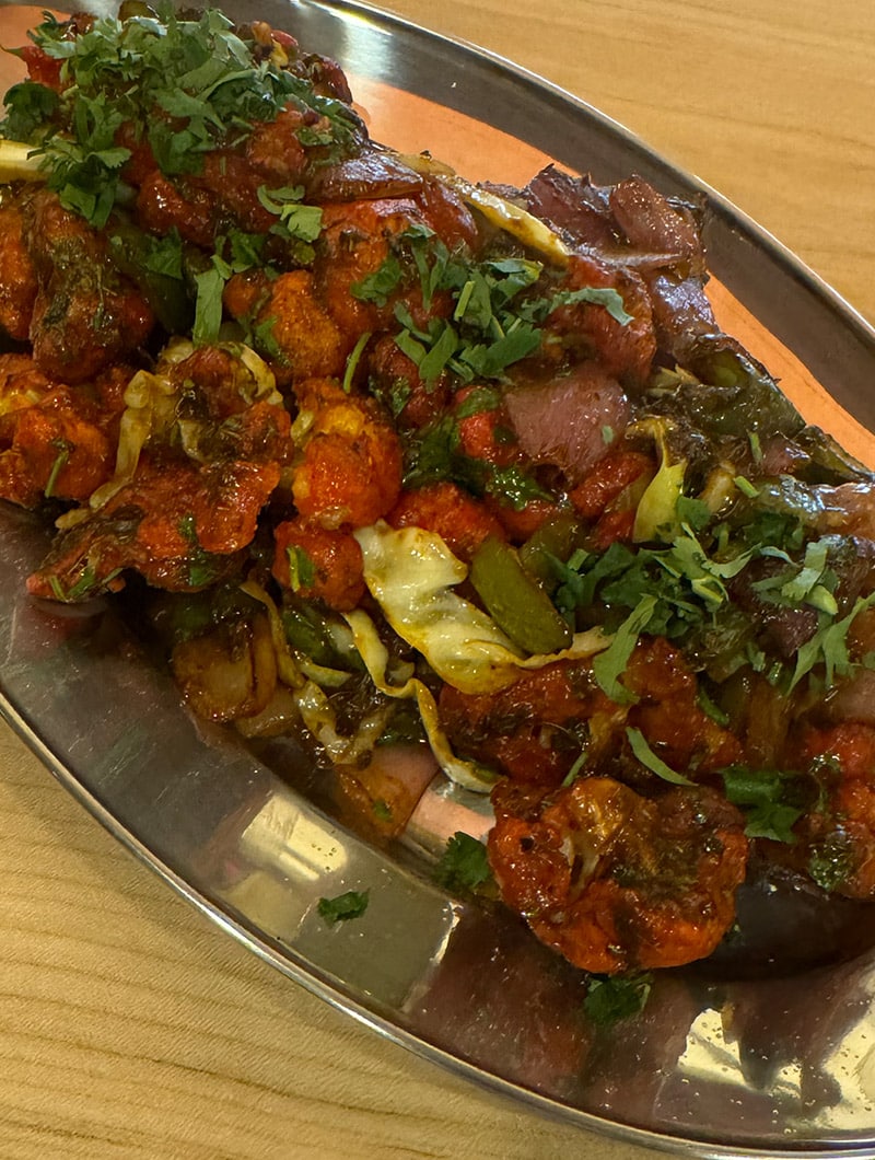 Crispy cauliflower florets tossed in a tangy, spicy Indo-Chinese Manchurian sauce