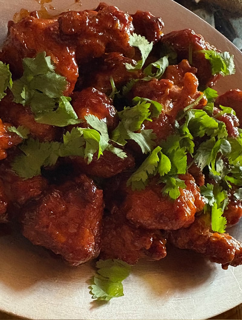 Boneless chicken tossed with onions, peppers, and a fiery Indo-Chinese chili sauce