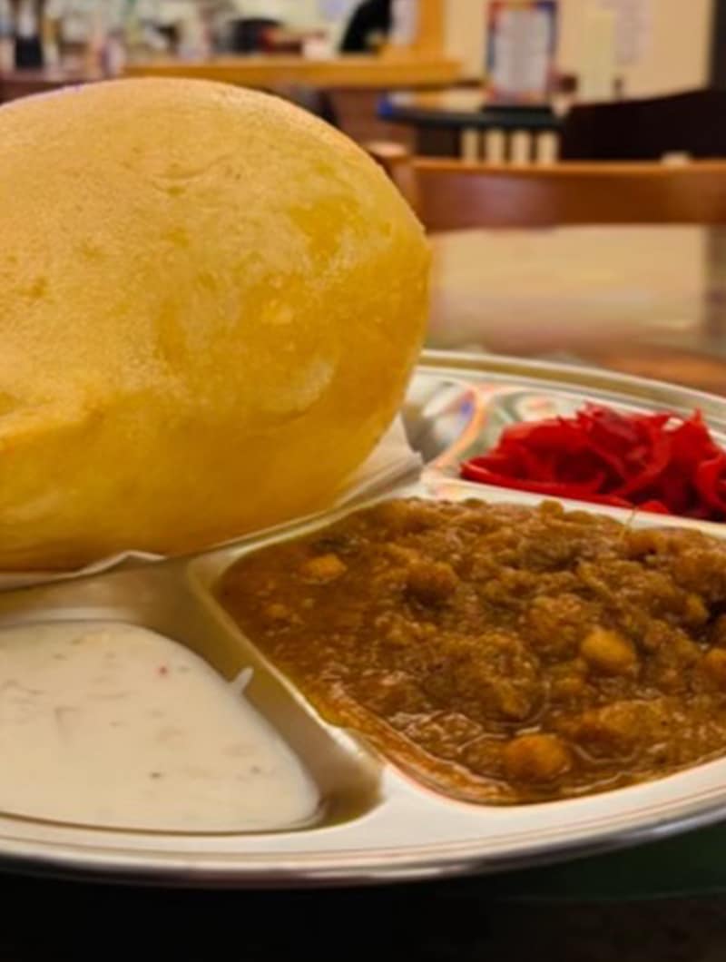 Fluffy deep-fried bhature bread paired with spiced chickpea curry