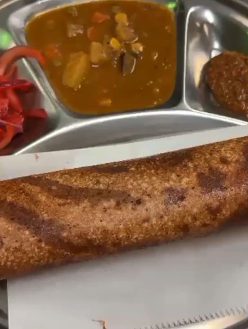 Golden crispy masala dosa stuffed with spiced potatoes, served with chutney and sambar